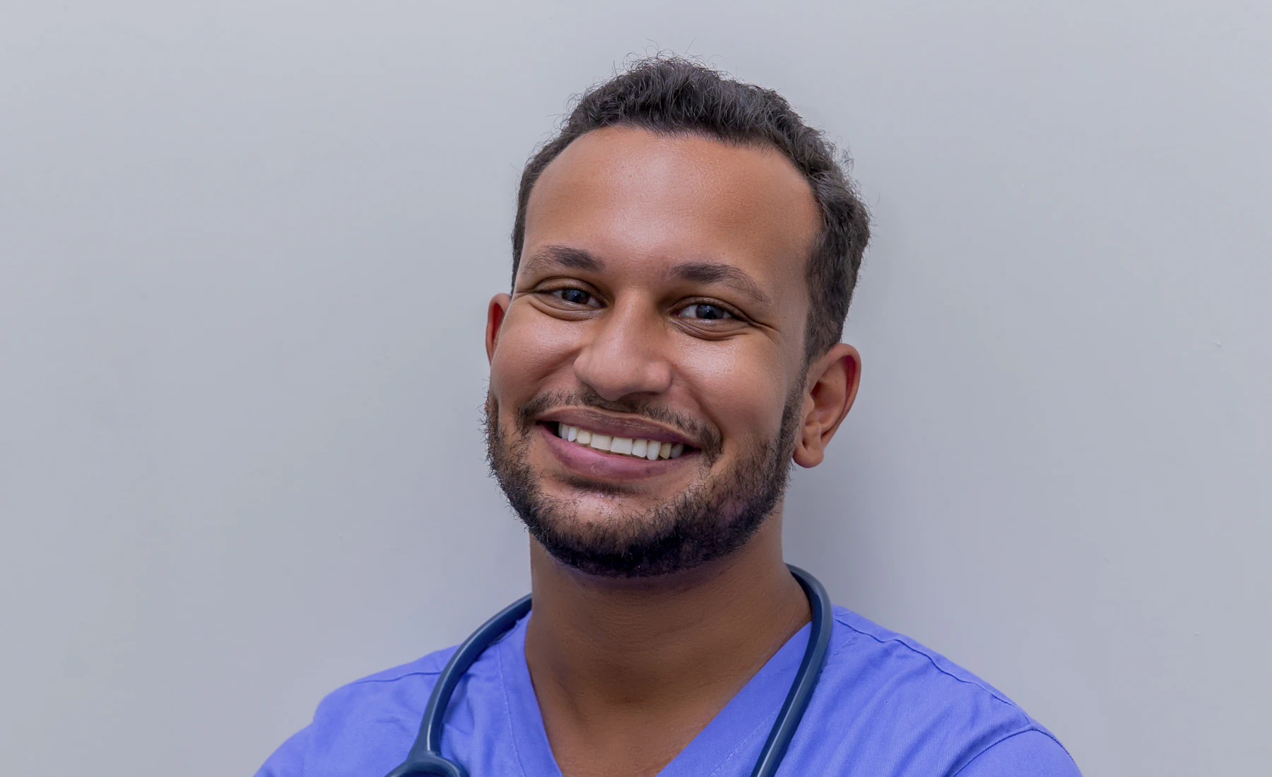 A Filipino nurse in Dubai, all smiles after his shift