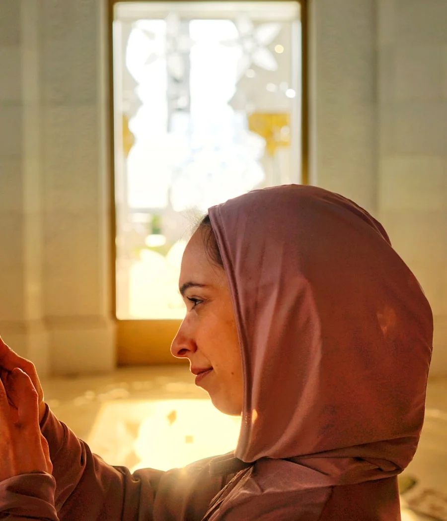 Amira at the mosque in Abu Dhabi, phone in hand