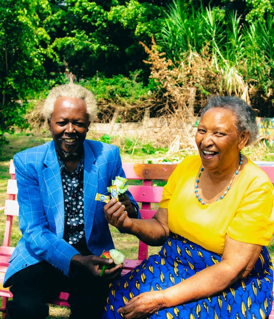 Her parents together on a bench, laughing in Khartoum