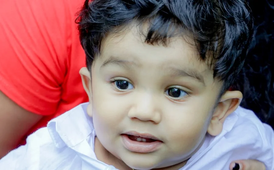His baby son in his mother's arms in Colombo